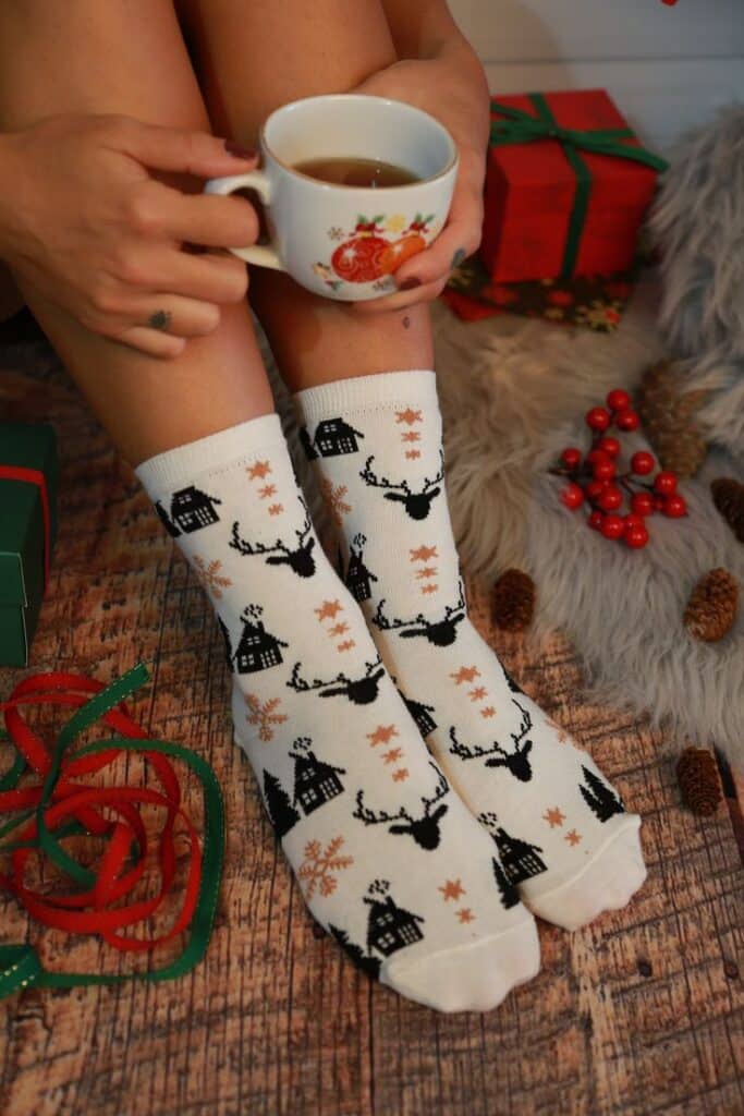 Women Deer Socks _ Funny Gift For Christmas _ Winter Soft Socks _ Colorful Socks _ Women Socks _ Crazy Socks _ Gift for Her _ Woven Socks Cozy Christmas socks and hot tea, surrounded by gifts and decorations on a wooden floor. | Sky Rye Design Cozy Christmas socks and hot tea, surrounded by gifts and decorations on a wooden floor.