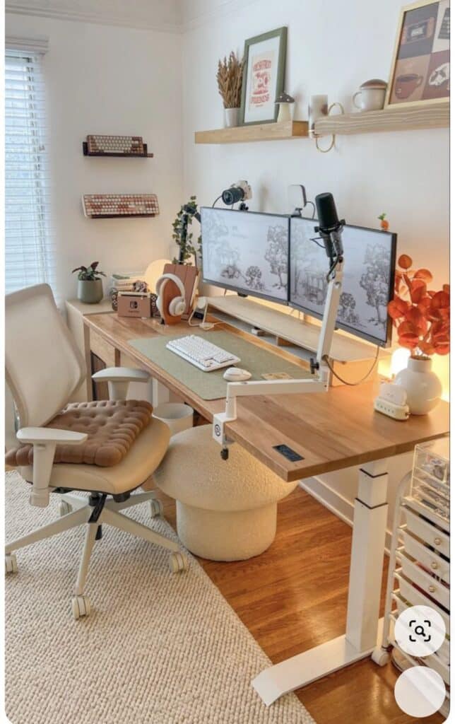 Screenshot Stylish home office with dual monitors, ergonomic chair, and decor on a wooden desk in a bright, cozy setup. | Sky Rye Design Stylish home office with dual monitors, ergonomic chair, and decor on a wooden desk in a bright, cozy setup.