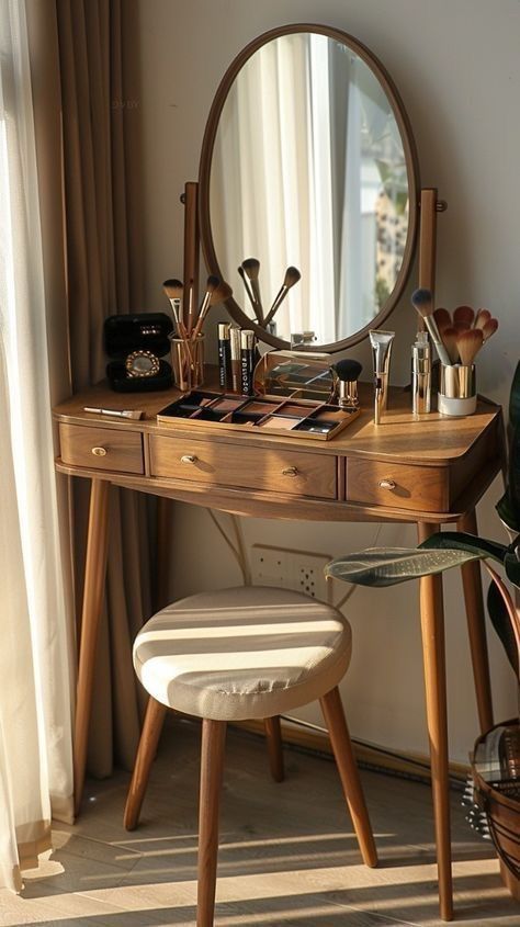 Elegant wooden vanity table with mirror, makeup brushes, and cosmetics, illuminated by natural sunlight.