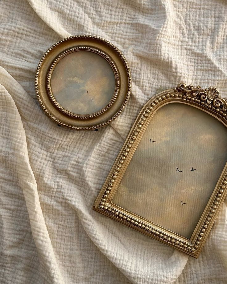 a4d7a20d-39de-4fe7-8fd5-b27f36084c19 Vintage gold frames with cloudy sky and birds, set on textured fabric background. | Sky Rye Design Vintage gold frames with cloudy sky and birds, set on textured fabric background.