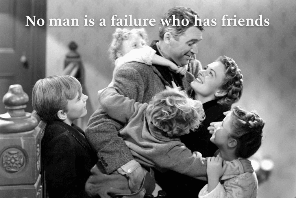 Black-and-white photo of a joyful family embracing, with text: No man is a failure who has friends.