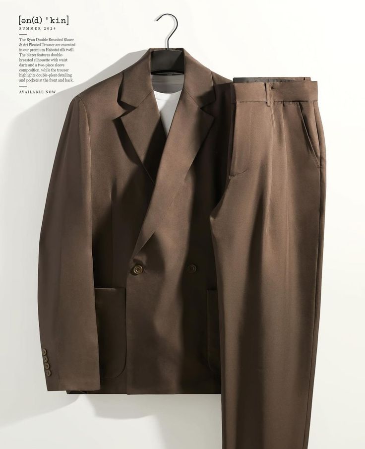 Brown double-breasted blazer and trousers on hanger, highlighting sleek and formal men's fashion.
