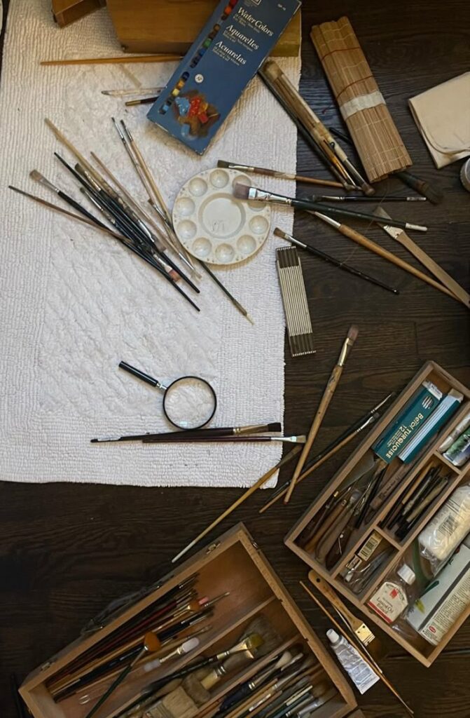 b471cfe6-1f06-45b4-a6ba-52e50c0b687d Art supplies and brushes on wood and white surface, ready for watercolor painting. | Sky Rye Design Art supplies and brushes on wood and white surface, ready for watercolor painting.