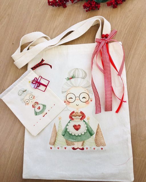 Festive tote bag with cute grandma design, red checkered ribbon, and matching pouch on wooden background.