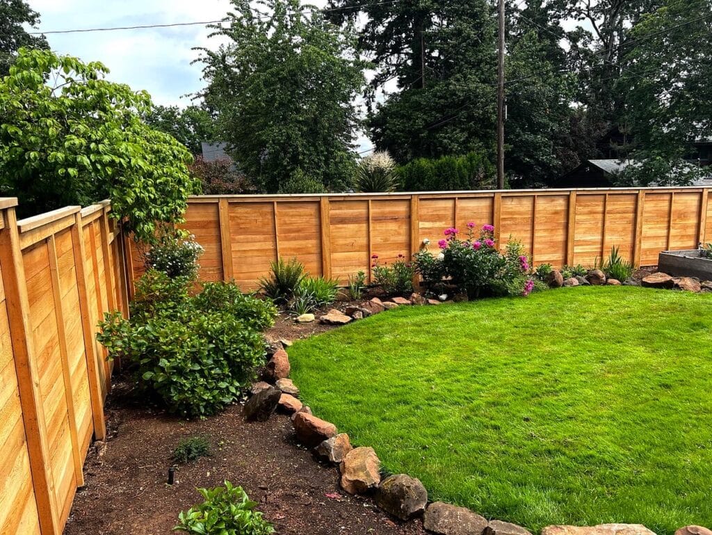 best-fencing-company-in-salem-or Lush garden with wooden fence, vibrant flowers, and green lawn under a clear sky. Perfect outdoor landscaping setup. | Sky Rye Design Lush garden with wooden fence, vibrant flowers, and green lawn under a clear sky. Perfect outdoor landscaping setup.