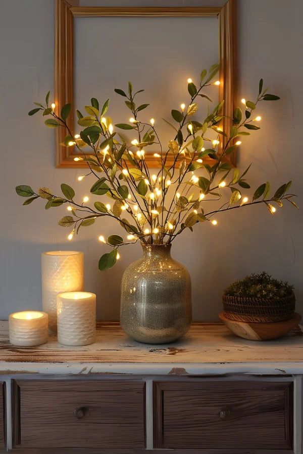bf4e21f2ac360808f4d07b4daa20f6f4 Elegant vase with lighted branches and candles on a rustic table, creating a cozy, ambient home decor setting. | Sky Rye Design Elegant vase with lighted branches and candles on a rustic table, creating a cozy, ambient home decor setting.