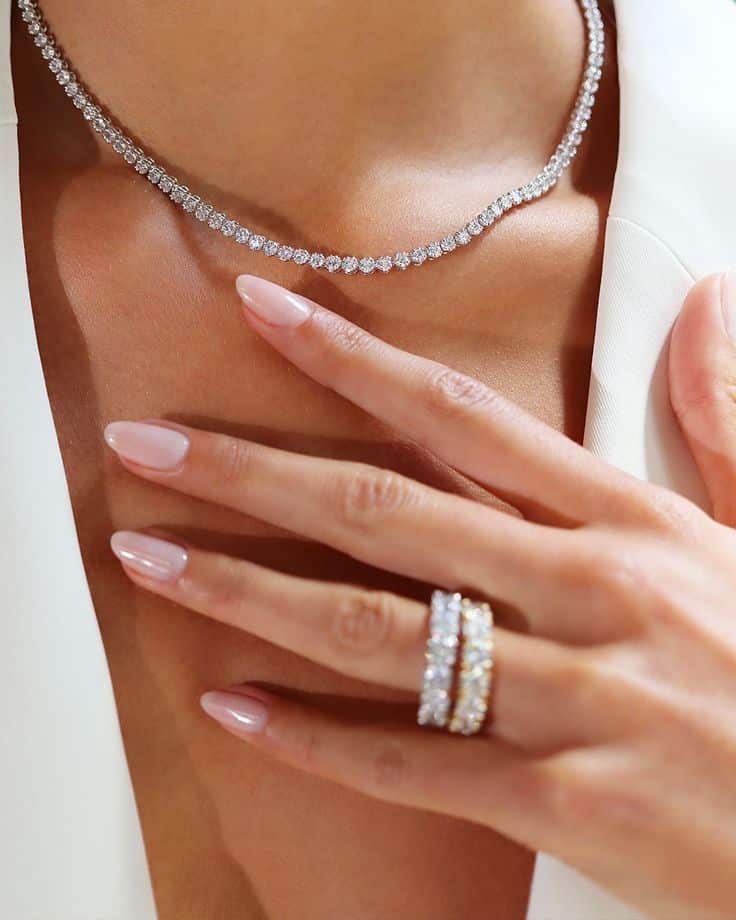 bf6ab087-77b7-4fc2-9715-d7b592428a8c Elegant diamond necklace and rings on woman with manicured nails. | Sky Rye Design Elegant diamond necklace and rings on woman with manicured nails.