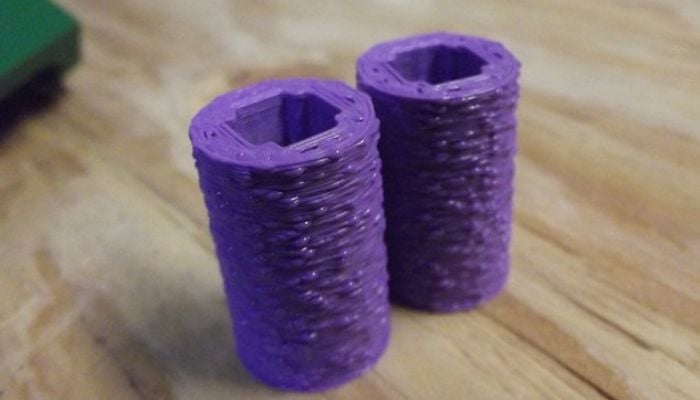 blobs Two hexagonal purple 3D-printed objects on a wooden surface. | Sky Rye Design Two hexagonal purple 3D-printed objects on a wooden surface.