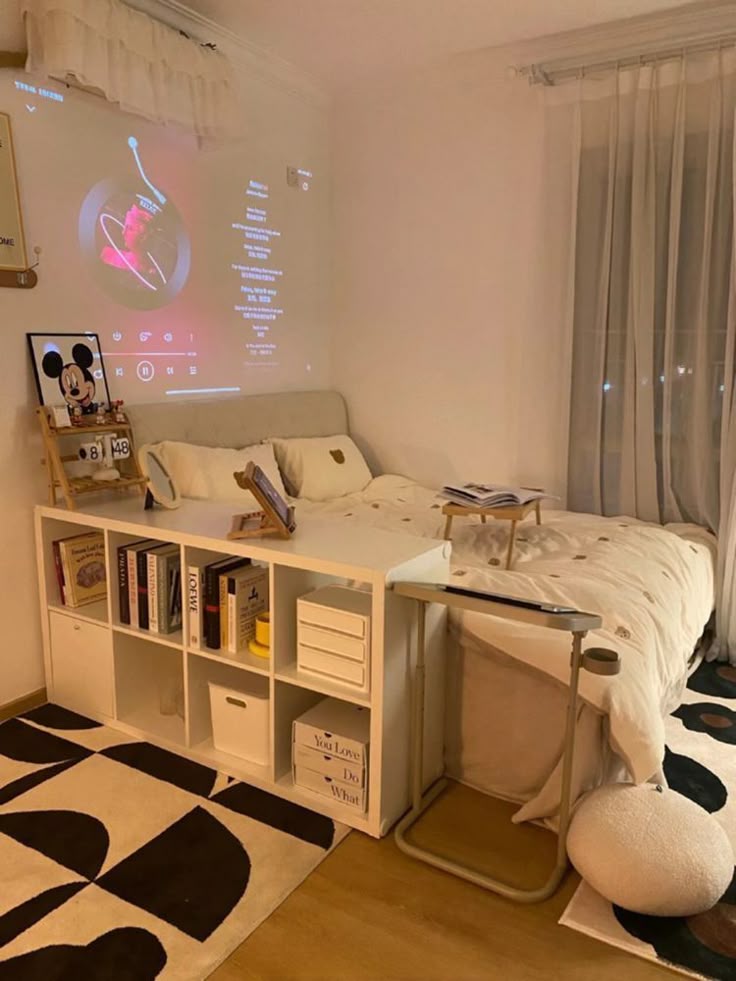 Cozy bedroom with a projector displaying music, books on shelves, and elegant decor for a relaxing atmosphere.