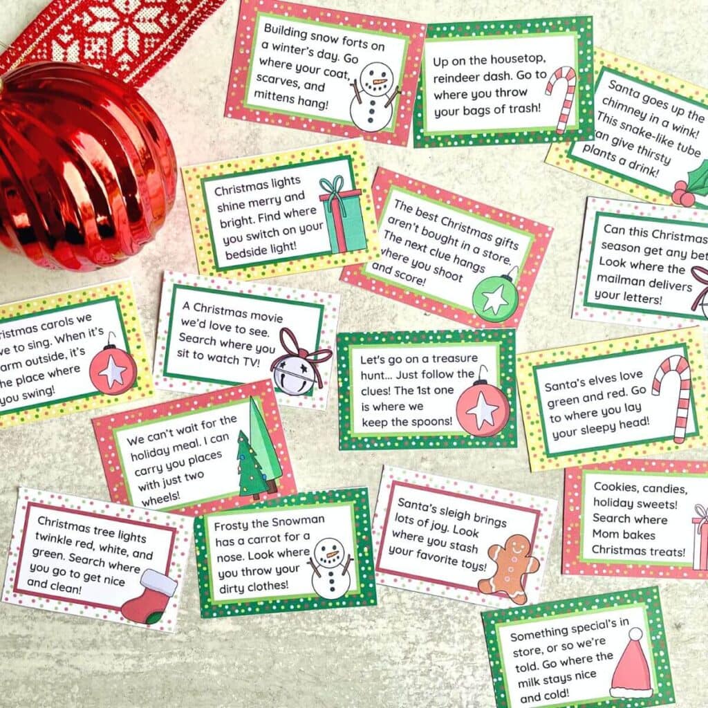 Christmas scavenger hunt clue cards laid out with festive decorations.