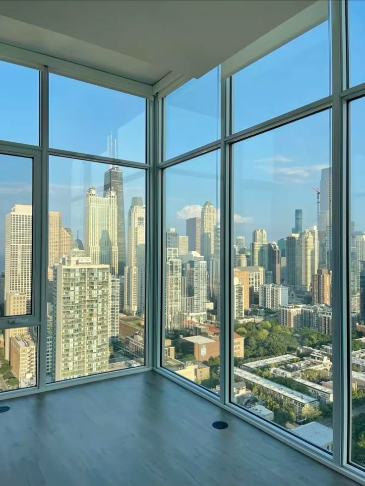 city apartment🛋️ Modern city skyline view from a high-rise corner window, featuring tall buildings and a clear blue sky. | Sky Rye Design Modern city skyline view from a high-rise corner window, featuring tall buildings and a clear blue sky.