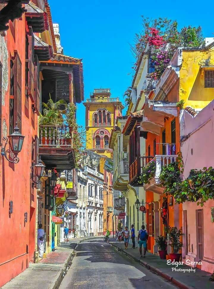 colombia Colorful colonial street with vibrant buildings and balconies, Cartagena, daytime. | Sky Rye Design Colorful colonial street with vibrant buildings and balconies, Cartagena, daytime.