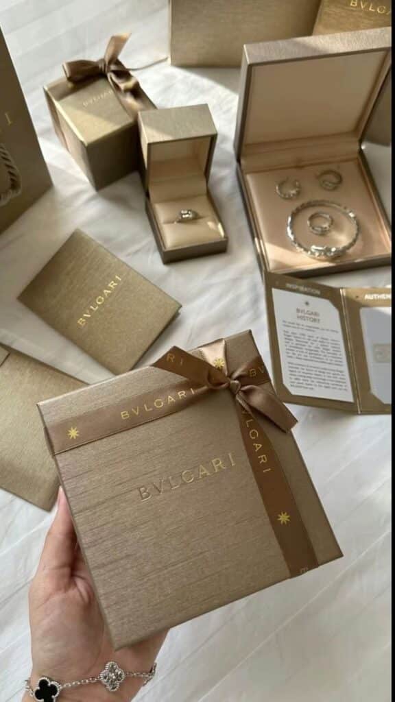 Luxurious Bvlgari jewelry packaging with ring, bracelet, and elegant gift boxes on white background.