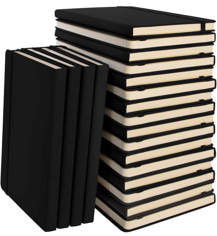Stack of black notebooks with elastic straps, perfect for journaling or organizing thoughts. Ideal for students and professionals.