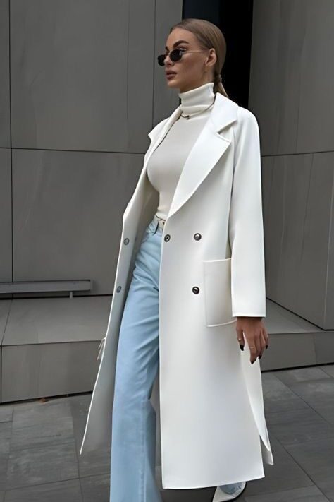 dbc95ee6-e638-4d1e-862d-b64af68c8073 Fashionable woman in a white coat, turtleneck, and sunglasses, walking confidently on a city street. | Sky Rye Design Fashionable woman in a white coat, turtleneck, and sunglasses, walking confidently on a city street.