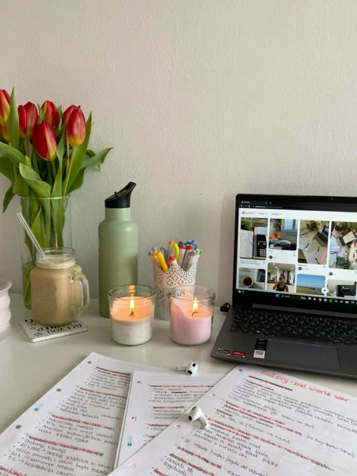 dfaeb7cc-1f2c-4935-9e15-e1c14f01a3cf Cozy study setup with notes, laptop, candles, tulips, and a coffee cup for productive work at a tidy desk. | Sky Rye Design Cozy study setup with notes, laptop, candles, tulips, and a coffee cup for productive work at a tidy desk.