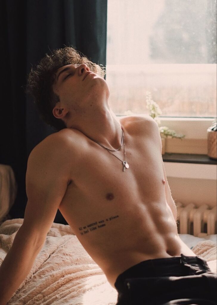 dfbe31da75ea77c364cf24b53a356bce Young man relaxing shirtless by a window in natural light. | Sky Rye Design Young man relaxing shirtless by a window in natural light.