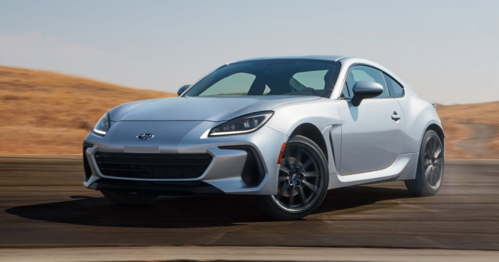 image Silver Subaru BRZ sports coupe cornering on racetrack, dynamic motion against dry hillside | Sky Rye Design Silver Subaru BRZ sports coupe cornering on racetrack, dynamic motion against dry hillside