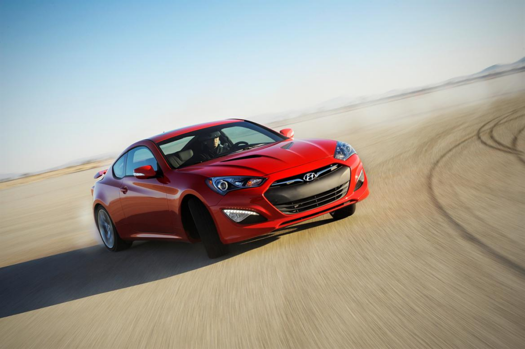 image Red Hyundai sports coupe drifting on dry desert track with motion blur, dynamic speed and handling shot | Sky Rye Design Red Hyundai sports coupe drifting on dry desert track with motion blur, dynamic speed and handling shot
