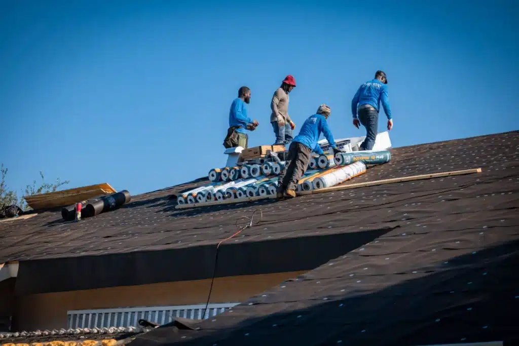 distinctive-roof-repair-and-water-proofing-2048x1366 Workers installing roofing materials on a house under clear blue skies. | Sky Rye Design Workers installing roofing materials on a house under clear blue skies.
