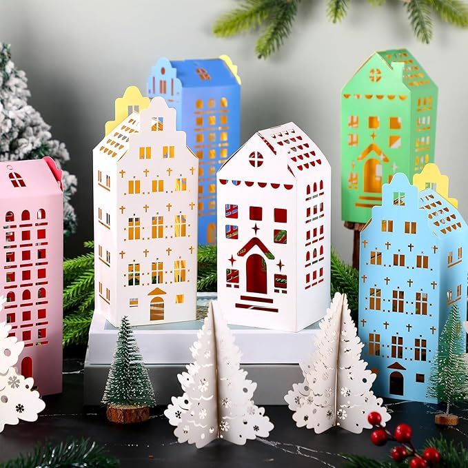 e2c1e749973139a92313e8573e05a1e9 Colorful paper house lanterns with festive designs amidst a winter scene featuring miniature trees and decorations. | Sky Rye Design Colorful paper house lanterns with festive designs amidst a winter scene featuring miniature trees and decorations.