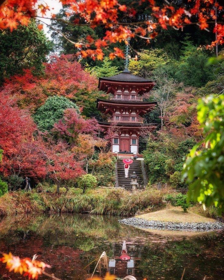 e855c43a-00bf-47af-be90-840c743dc29b Pagoda amidst vibrant autumn foliage reflects in serene pond. | Sky Rye Design Pagoda amidst vibrant autumn foliage reflects in serene pond.