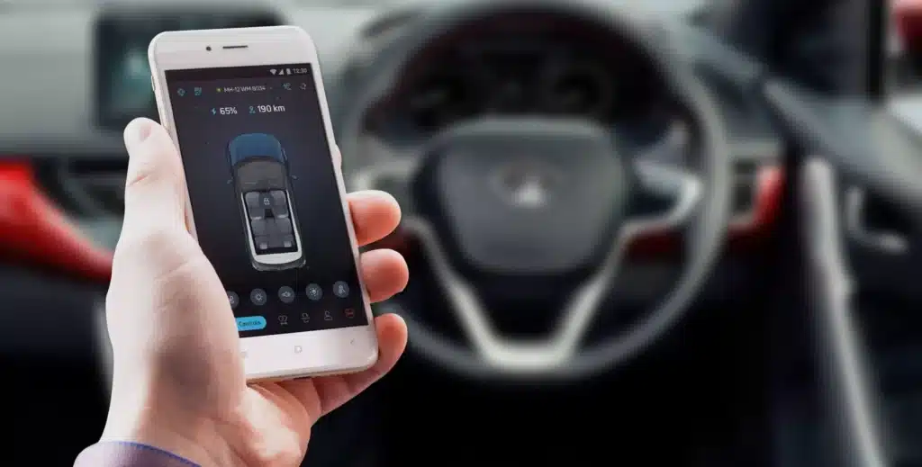 evc-banner Person using smartphone car control app inside vehicle, displaying battery and lock status. | Sky Rye Design Person using smartphone car control app inside vehicle, displaying battery and lock status.