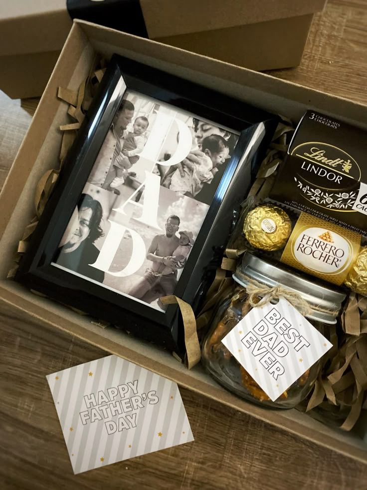 Father's Day gift box with chocolates, a personalized photo frame, and a card reading 'Happy Father's Day'.