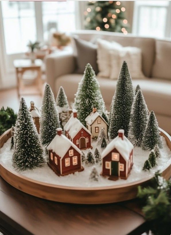 f7bec7e11f180b8fbf9911e52b7c2526 Miniature snowy village scene with model houses and trees on a cozy, festive table display. | Sky Rye Design Miniature snowy village scene with model houses and trees on a cozy, festive table display.