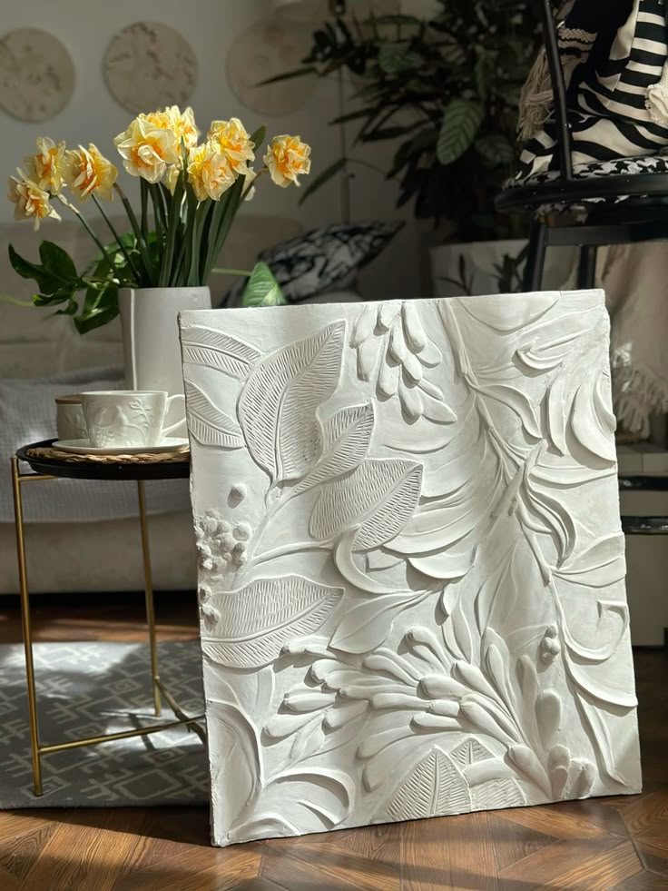 fae878fc-e145-4c5d-b72e-5580b3d6e5fe Decorative floral relief art panel in a cozy room with yellow flowers and modern decor elements. | Sky Rye Design Decorative floral relief art panel in a cozy room with yellow flowers and modern decor elements.