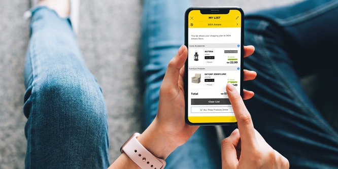 ikea-mobile-app-on-phone-666x333 Person using a mobile shopping app to view and manage their online shopping list on a smartphone screen. | Sky Rye Design Person using a mobile shopping app to view and manage their online shopping list on a smartphone screen.