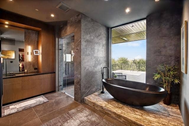 image Luxurious modern bathroom with freestanding black tub, large window view, and sleek minimalist design elements. | Sky Rye Design Luxurious modern bathroom with freestanding black tub, large window view, and sleek minimalist design elements.