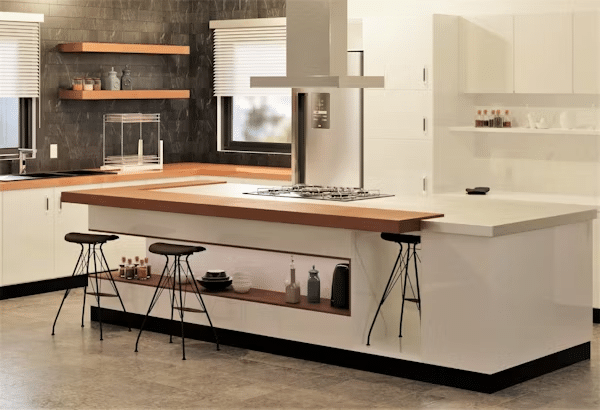 Modern kitchen with island, bar stools, and sleek decor. Stylish shelves and neutral tones enhance the space.