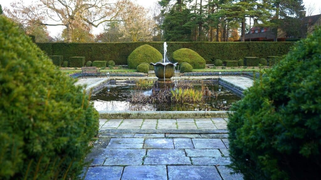 image Elegant garden with a central fountain, neatly trimmed hedges, and tranquil reflecting pond. | Sky Rye Design Elegant garden with a central fountain, neatly trimmed hedges, and tranquil reflecting pond.