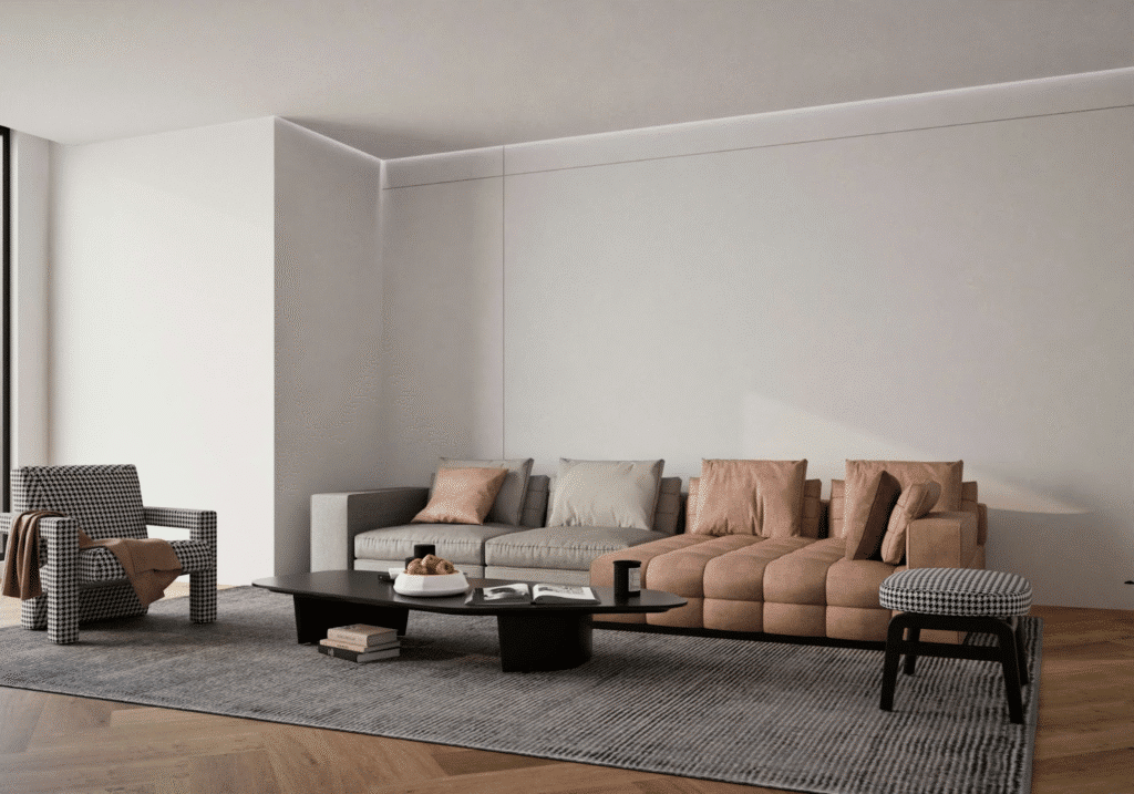 Modern living room with beige sectional sofa, houndstooth armchair, coffee table, and minimal decor on a gray rug.