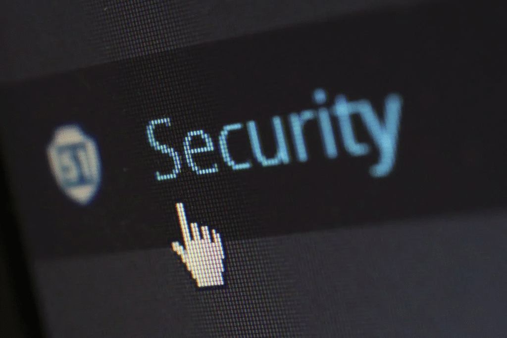 Computer screen displaying the word security with a hand cursor icon.