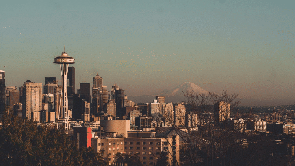 image Seattle skyline with Space Needle and Mount Rainier under a clear sky. | Sky Rye Design Seattle skyline with Space Needle and Mount Rainier under a clear sky.