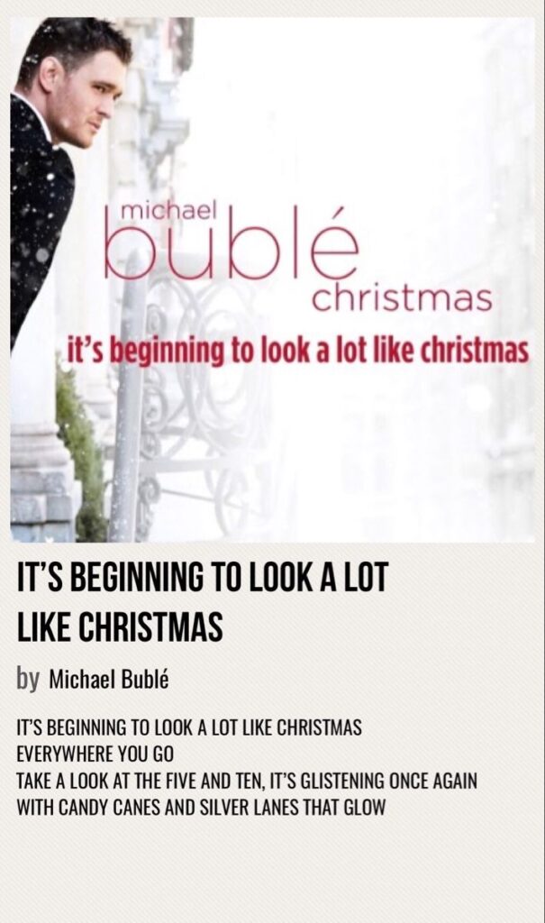 Michael Bublé Christmas album cover with snowy background and song lyrics from It's Beginning to Look a Lot Like Christmas.