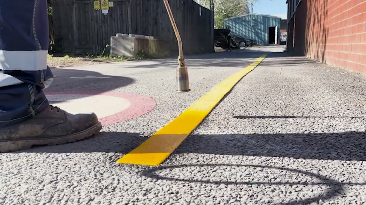 maxresdefault Worker using heat to apply a yellow line on asphalt in a construction area. | Sky Rye Design Worker using heat to apply a yellow line on asphalt in a construction area.