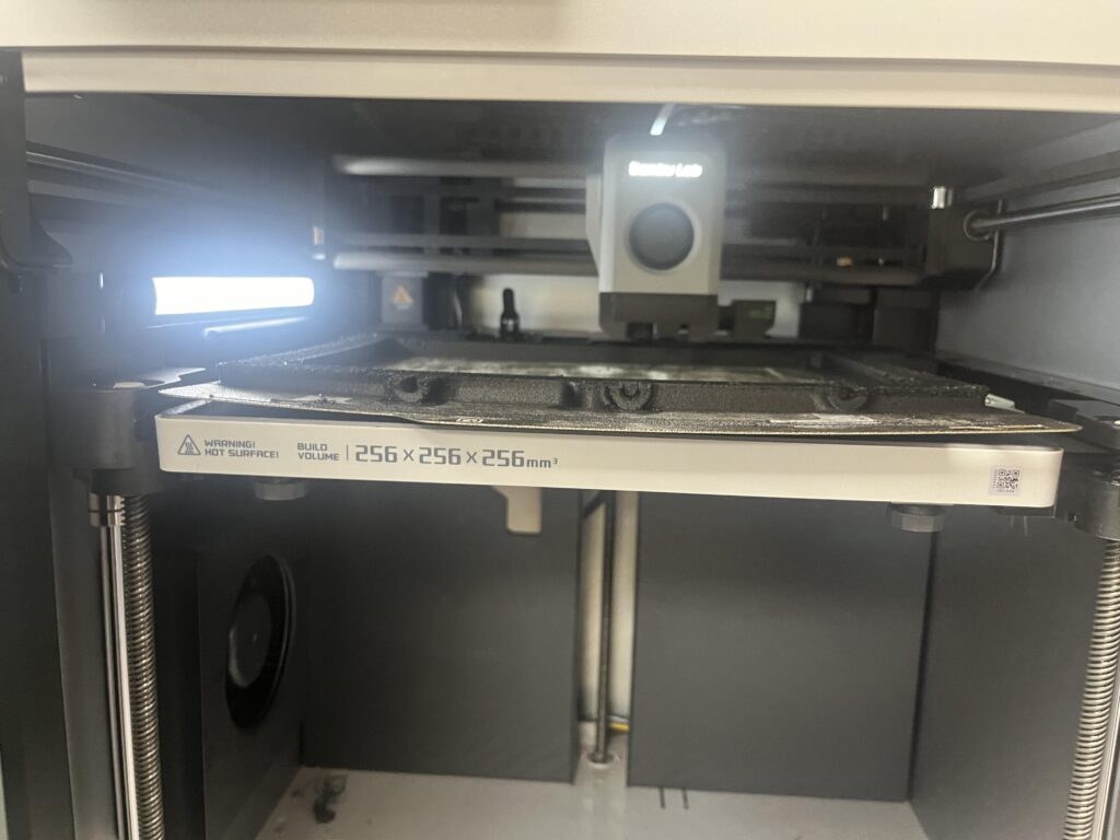 paht-carbon-fiber-warping-issues-v0-0kjyuvkzmk8d1 Close-up of a 3D printer interior, showing build volume dimensions and a warning for hot surfaces. | Sky Rye Design Close-up of a 3D printer interior, showing build volume dimensions and a warning for hot surfaces.