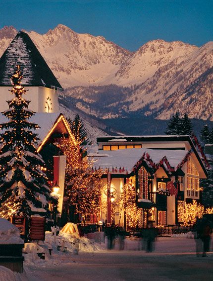 perfect christmas town vail CO Snowy village with glowing holiday lights, set against a backdrop of majestic mountain peaks at dusk. | Sky Rye Design Snowy village with glowing holiday lights, set against a backdrop of majestic mountain peaks at dusk.