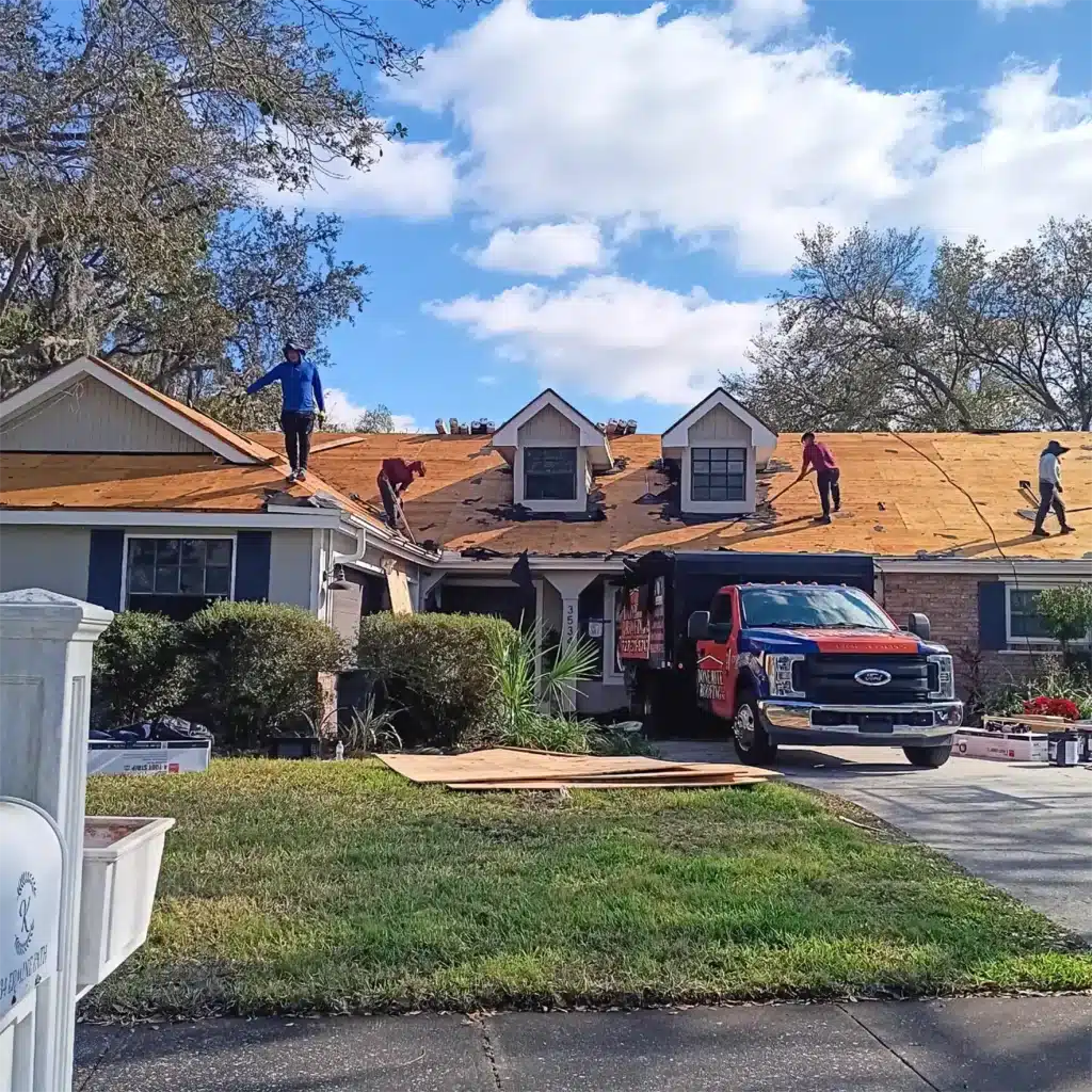 roof-replacement-in-progress-3 Roofers working on house roof renovation with truck and tools in front yard under a clear blue sky. | Sky Rye Design Roofers working on house roof renovation with truck and tools in front yard under a clear blue sky.