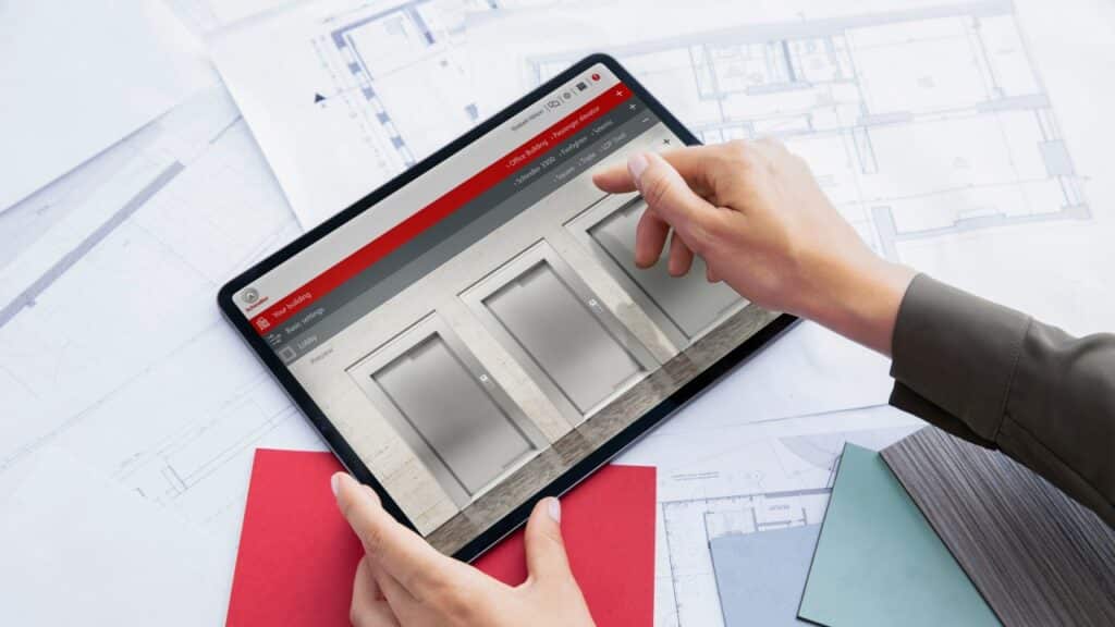 schindler-plan-and-design-6 Person using an architectural design app on a tablet over blueprints and color samples. | Sky Rye Design Person using an architectural design app on a tablet over blueprints and color samples.