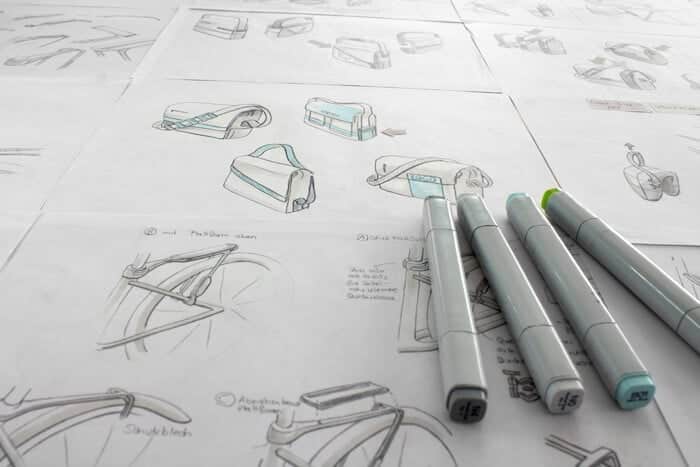 sketches-of-bags-and-bikes Bicycle bag design sketches with markers on paper, showcasing creative concepts and detailed illustrations. | Sky Rye Design Bicycle bag design sketches with markers on paper, showcasing creative concepts and detailed illustrations.