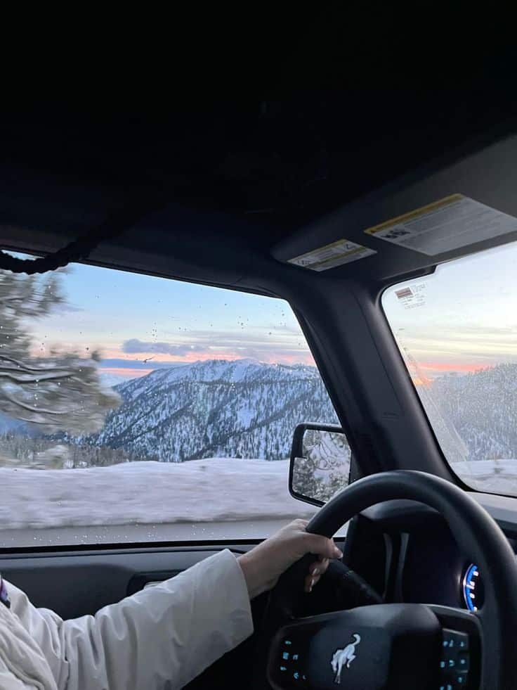 snow sunset snowboarding winter drive Driving through snowy mountain landscape at sunset, capturing breathtaking views from inside a car. | Sky Rye Design Driving through snowy mountain landscape at sunset, capturing breathtaking views from inside a car.