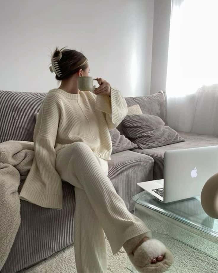 sweat pants _ sweat suit _ cozy slippers _ cozy aesthetic _ studying aesthetic Cozy woman in cream loungewear enjoying coffee on a sofa near a laptop, bright room. | Sky Rye Design Cozy woman in cream loungewear enjoying coffee on a sofa near a laptop, bright room.