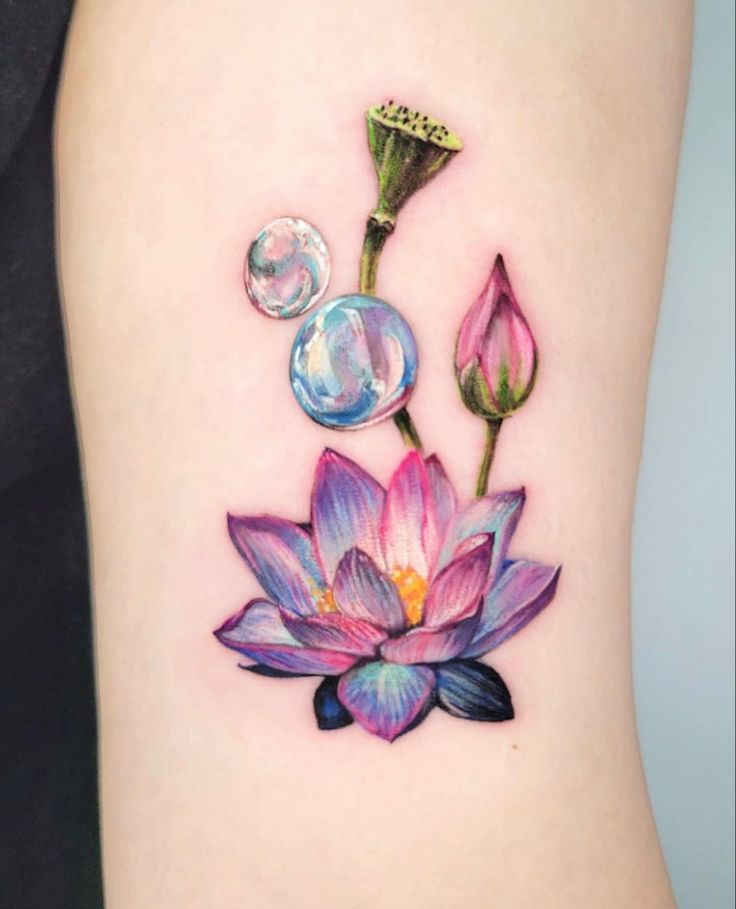tattooist_cix on Instagram Colorful lotus flower tattoo with water droplets, featuring vibrant petals and delicate details on light skin. | Sky Rye Design Colorful lotus flower tattoo with water droplets, featuring vibrant petals and delicate details on light skin.