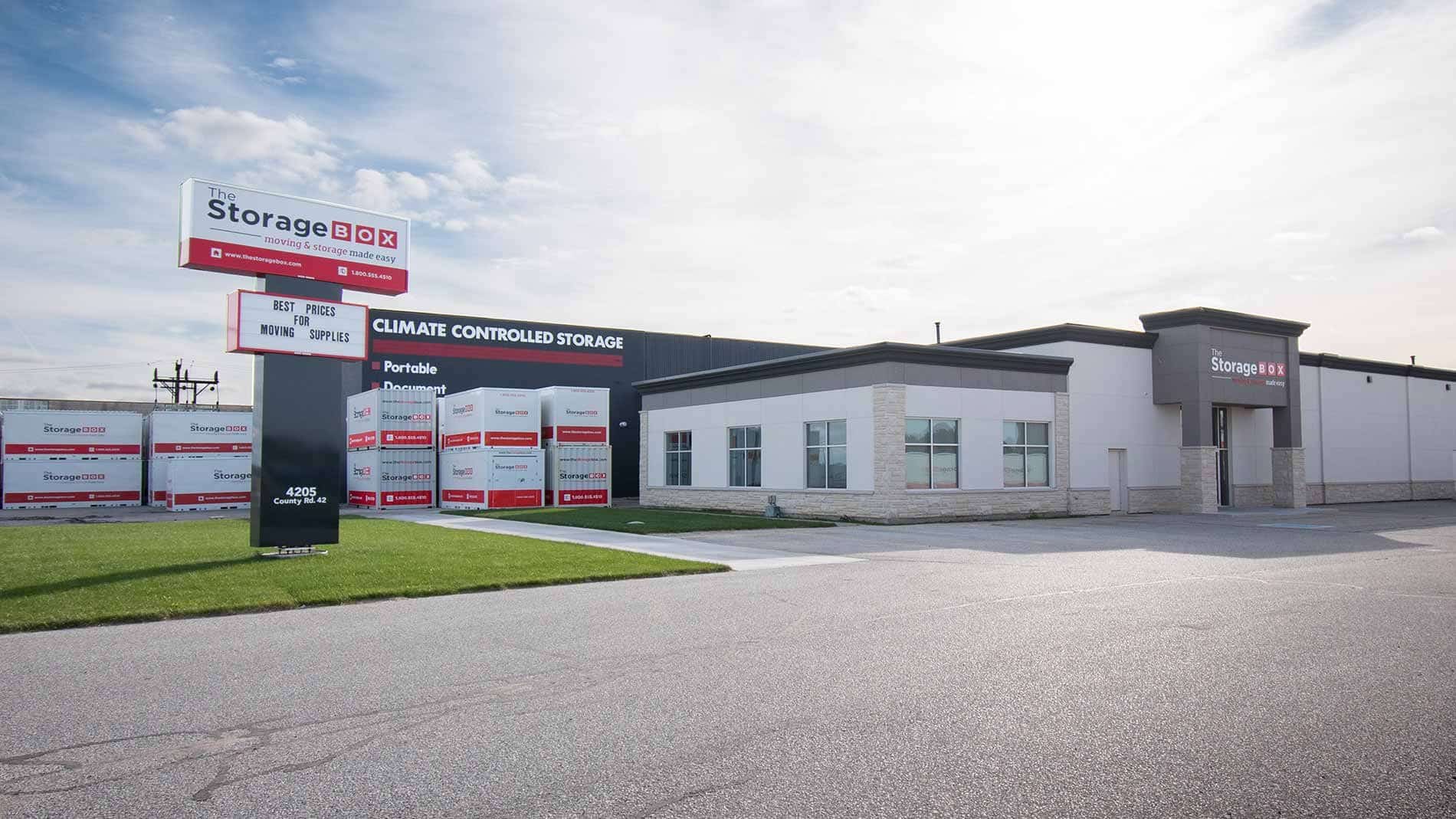 the-storage-box-headquarters Storage facility exterior with climate-controlled units and signage for moving supplies. | Sky Rye Design Storage facility exterior with climate-controlled units and signage for moving supplies.
