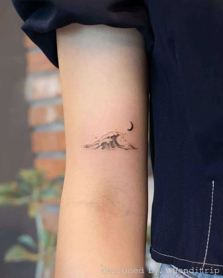 _ Minimalist wave and crescent moon tattoo on arm, showcasing delicate design and artistry. | Sky Rye Design Minimalist wave and crescent moon tattoo on arm, showcasing delicate design and artistry.