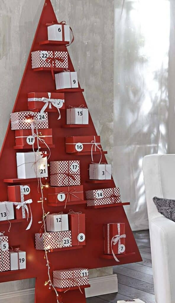 Screenshot Red Christmas tree-shaped advent calendar with numbered gift boxes and lights for holiday decor. | Sky Rye Design Red Christmas tree-shaped advent calendar with numbered gift boxes and lights for holiday decor.